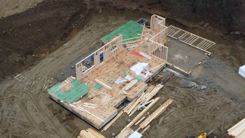 2025-03-31 - foundation with piles of lumber